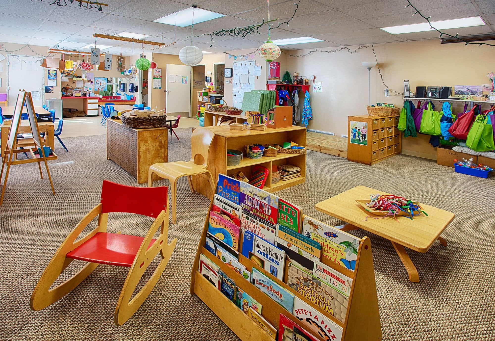 A teacher connecting with a child at Blue Skies Exploration Academy